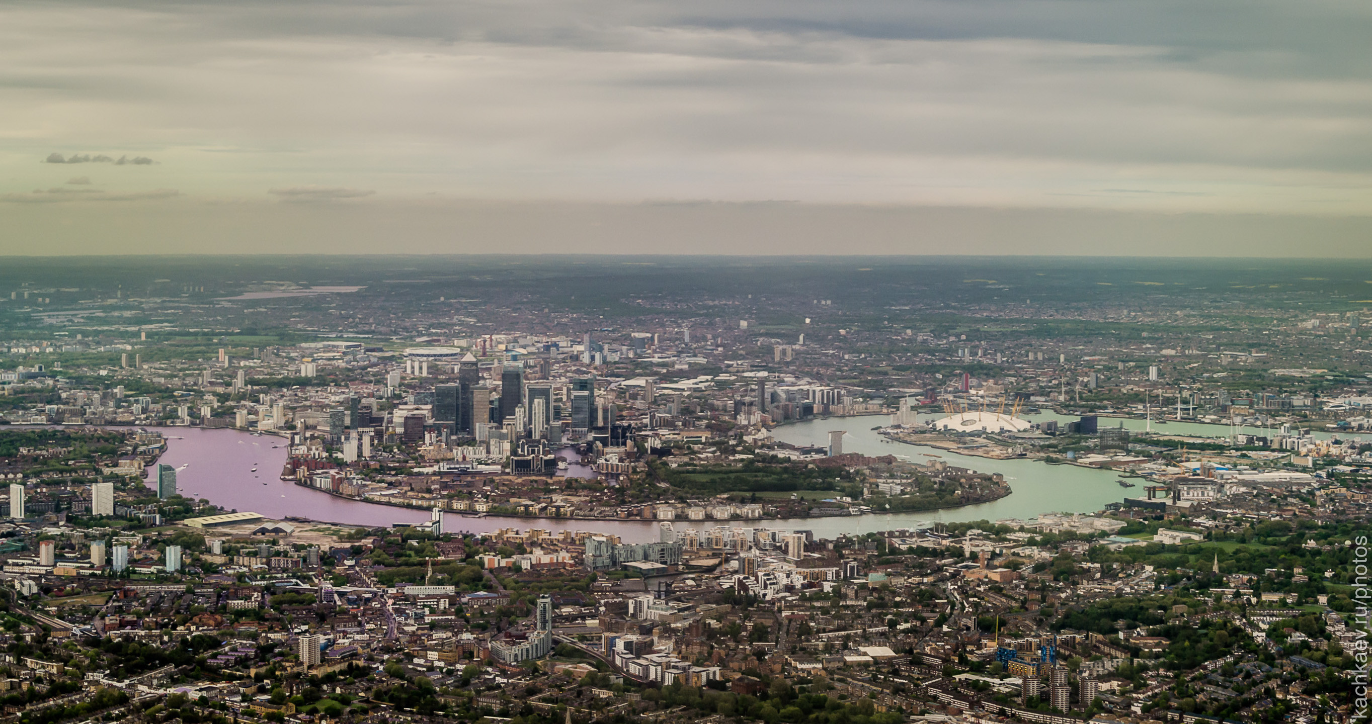 Aerial reference photograph of Canary Wharf and the River Thames in London.